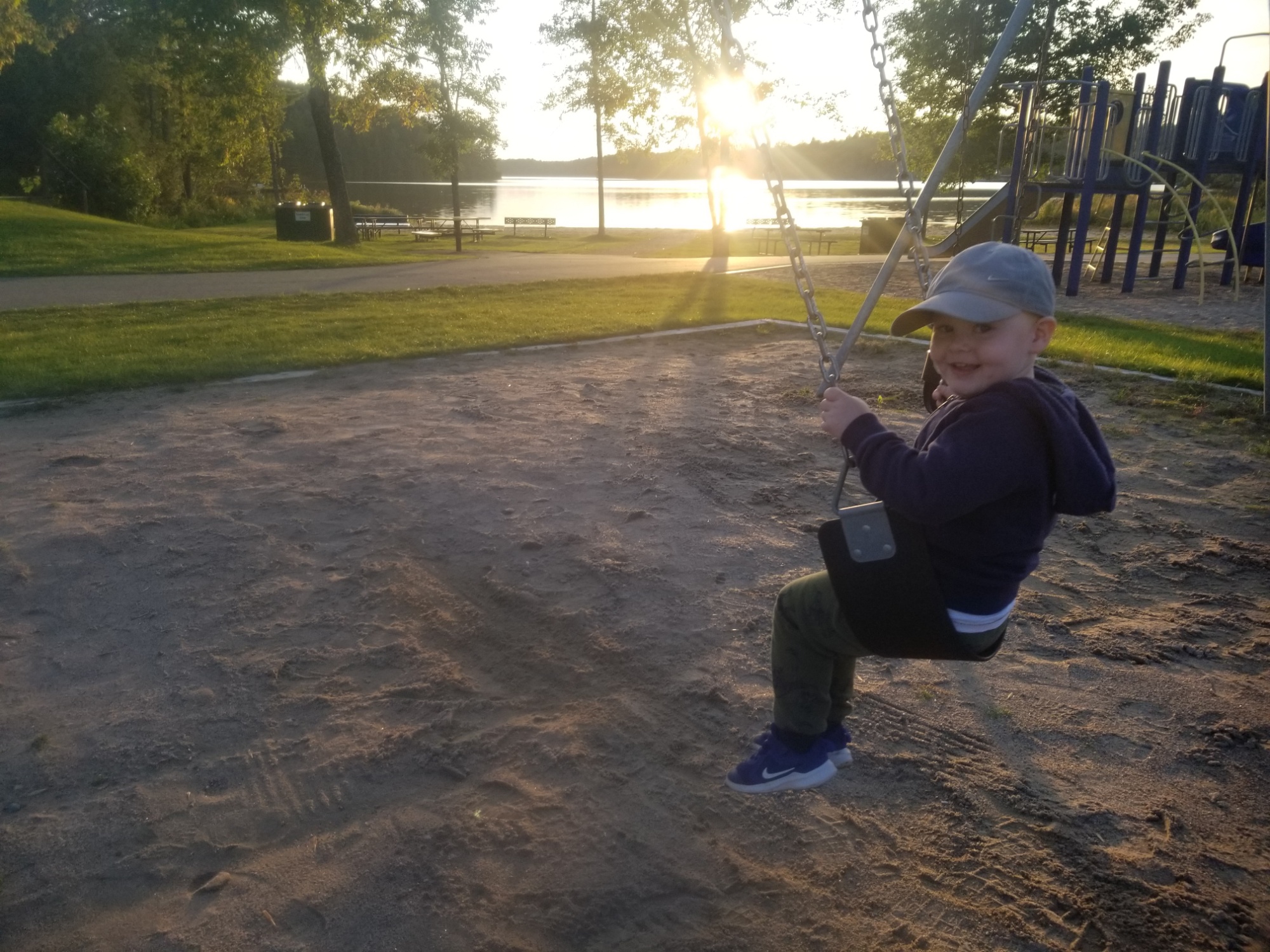 little boy swinging on swing